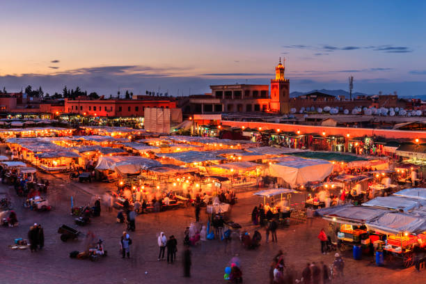 A bustling, colorful marketplace street scene in Morocco, North Africa.